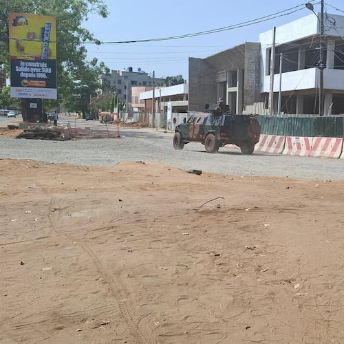 Soldiers ride in a military vehicle along a street amid an attempted coup in Cotonou Benin, Sunday Dec. 7, 2025. (AP Photo)