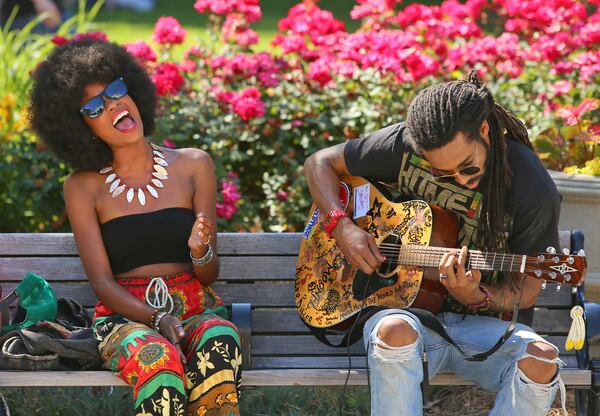 The performers CHE'ZEE attracted their share of fans performing on a park bench in Piedmont Park during the 36th annual Atlanta Jazz Festival on Sunday, May 26, 2013, in Atlanta.   (AJC 2013)