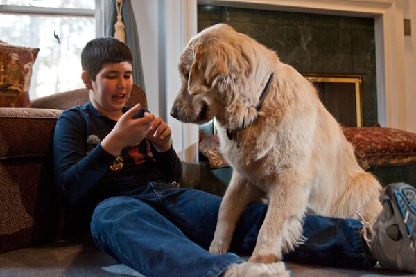 Iyal Winokur and his service dog, Chancer, have a private conversation. Chancer recently died, but another service dog, Quinn, joined the family before Chancer’s death. CONTRIBUTED BY BILL SIMMONS