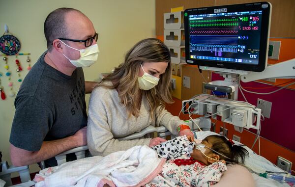Tamara and Justin Harris took turns sleeping in the ICU with their daughter Rynli while she waited at Children's Healthcare of Atlanta for a new heart. STEVE SCHAEFER FOR THE AJC