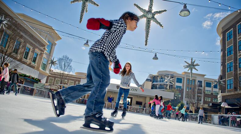 Alex Coney (left) and Abby Ostwald skate on the ice rink at Avalon in Alpharetta on Nov. 30, 2014. The rink will be open most days through February 2015. JONATHAN PHILLIPS / SPECIAL
