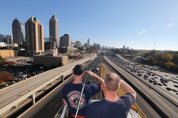 Several fire stations throughout Atlanta and DeKalb County radioed in to give tributes to Martinez as he passed through the downtown area about 2:30 p.m. Wednesday. JOHN SPINK / JSPINK@AJC.COM