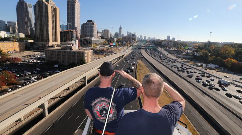 Several fire stations throughout Atlanta and DeKalb County radioed in to give tributes to Martinez as he passed through the downtown area about 2:30 p.m. Wednesday. JOHN SPINK / JSPINK@AJC.COM