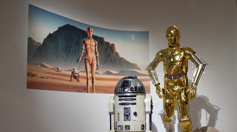 Production designer Norman Reynolds' robot R2-D2, left, and John Mollo's costume for the C-3PO character from the "Star Wars" franchise are displayed in the Cinema Gallery during a preview of the Lucas Museum of Narrative Art on Monday, Aug. 31, 2026, in Los Angeles. (AP Photo/Chris Pizzello)