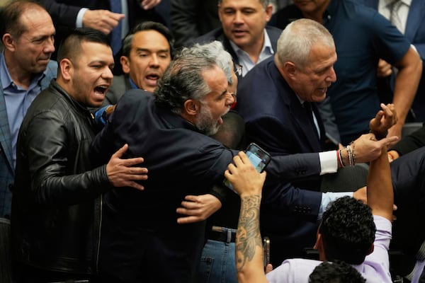 Colombian Interior Minister Armando Benedetti reacts after senators voted against a labor reform referendum proposed by the government, in Bogota, Colombia, Wednesday, May 14, 2025. (AP Photo/Fernando Vergara)