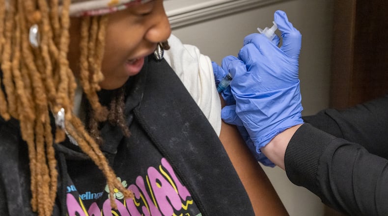Liah Pinkett, 14, got a back-to-school vaccine shot in July 2025. The CDC no longer recommends the flu vaccine for all children. (Arvin Temkar/AJC)
