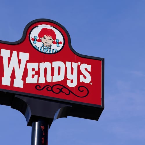 FILE - A sign stands over a Wendy's restaurant, Feb. 25, 2021, in Des Moines, Iowa. (AP Photo/Charlie Neibergall, File)