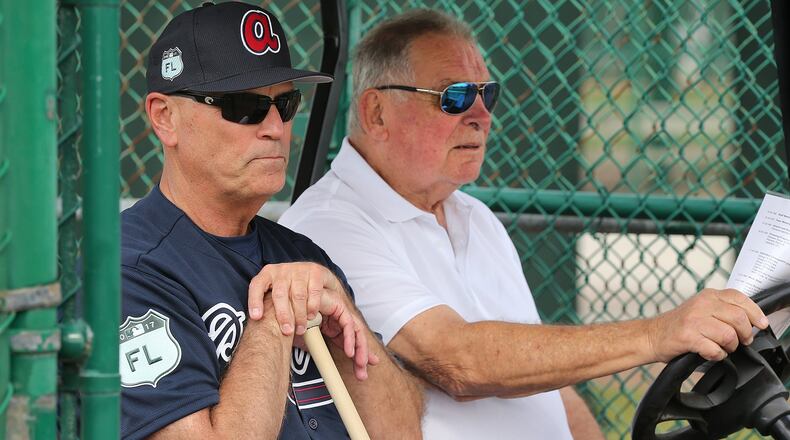 Braves manager Brian Snitker, watched a spring-training workout seated next to his mentor, legendary former Braves manager Bobby Cox. (Curtis Compton/AJC file photo)