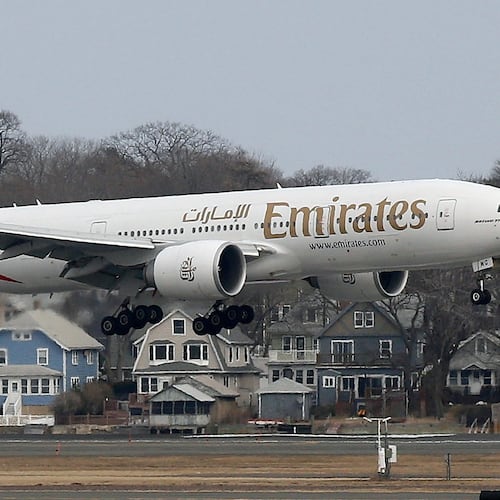 FILE - An Emirates Airlines Boeing 777 lands at Logan International Airport in Boston, March 10, 2014. (AP Photo/Michael Dwyer, File)