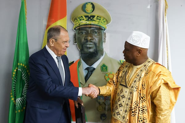 FILE - In this photo released by the Russian Foreign Ministry Press Service, Russian Foreign Minister Sergey Lavrov, left, and Guinea's Foreign Minister Morissanda Kouyate shake hands near a portrait of Guinea's President Mamadi Doumbouya in Conakry, Guinea, on June 3, 2024. (Russian Foreign Ministry Press Service via AP, File)