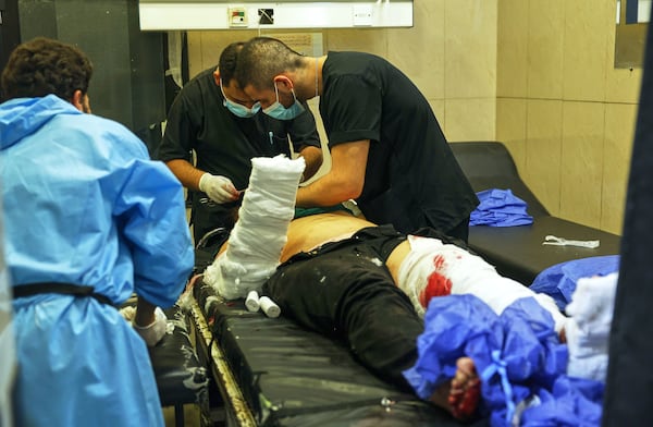 Doctors treat a man injured at Mar Elias church where a suicide bomber detonated himself in Dweil'a in the outskirts of Damascus, Syria, June 22, 2025. (AP Photo/Ghaith Alsayed)