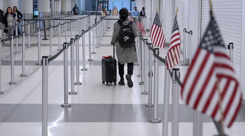 A traveler walks through a TSA security checkpoint in Terminal B, Friday, March 27, 2026, at Logan International Airport in Boston. (AP Photo/Robert F. Bukaty)