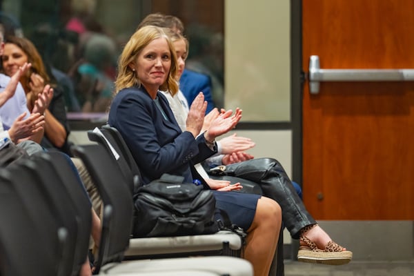 Superintendent Mary Elizabeth Davis applauds students receiving recognition during a school board meeting on Thursday, Feb. 15, 2024, in Canton at Cherokee School's Frank R. Petruzielo Educational Services Facility. (Jason Allen for the AJC)