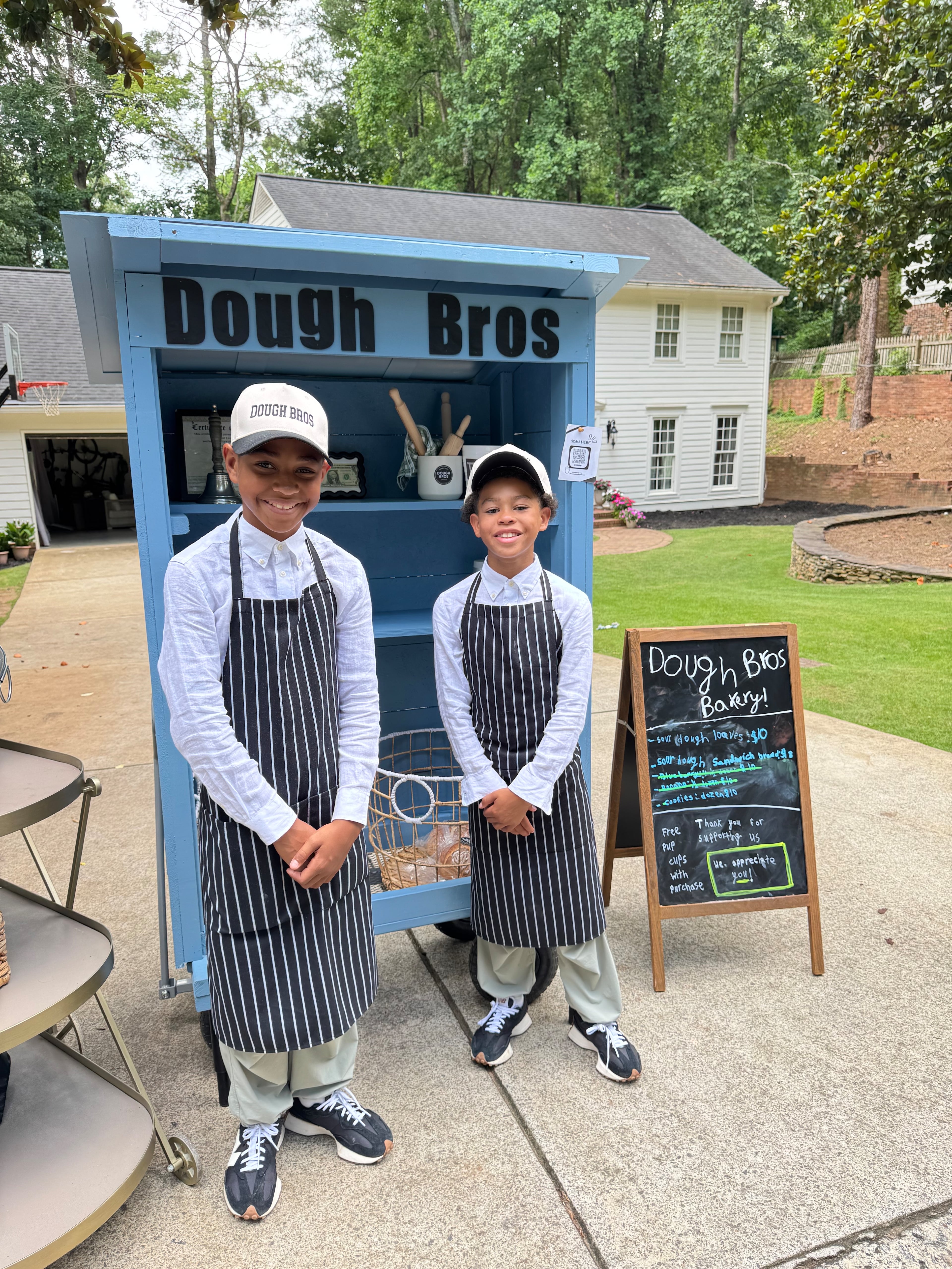 London (left) and Leo Lampley raised the money to pay for the supplies needed to build their bakery booth by washing cars in their neighborhood. (Courtesy of Sarah Lampley)
