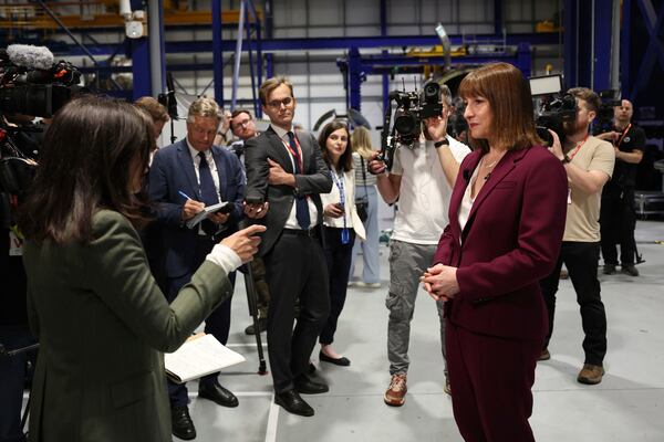 Britain's Chancellor of the Exchequer Rachel Reeves, right, speaks with the media at the Rolls-Royce factory in Derby, England following the announcement from the Office for National Statistics that the U.K. economy grew by 0.7% between January and March, Thursday, May 15, 2025. (Darren Staples/PA via AP)