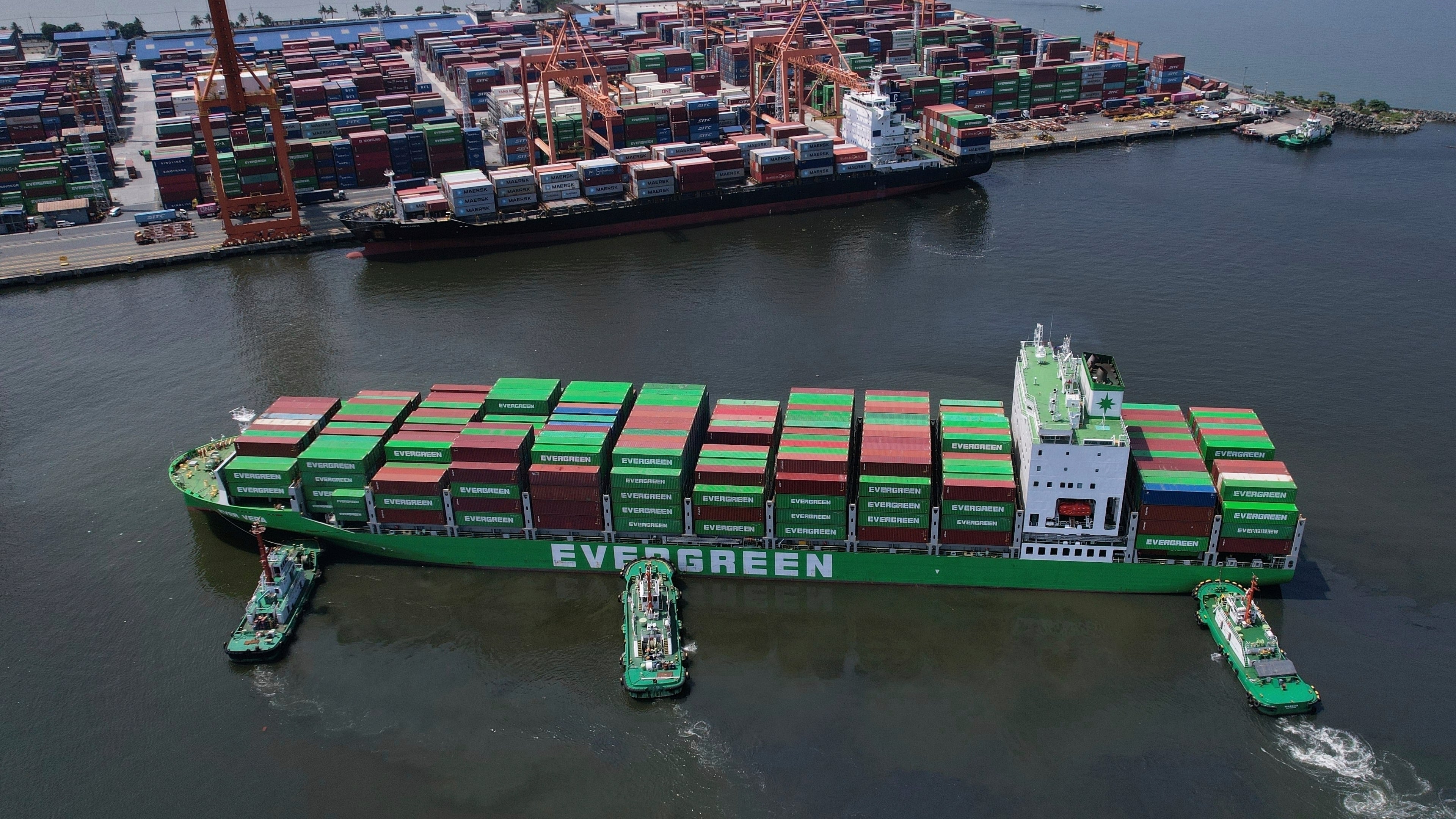 FILE - Tugboats assist a container ship as it prepares to dock at the Manila International Container Terminal at the Philippine capital April 8, 2025. (AP Photo/Aaron Favila, File)