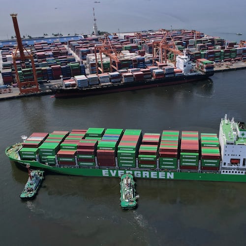 FILE - Tugboats assist a container ship as it prepares to dock at the Manila International Container Terminal at the Philippine capital April 8, 2025. (AP Photo/Aaron Favila, File)
