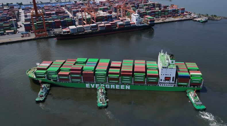 FILE - Tugboats assist a container ship as it prepares to dock at the Manila International Container Terminal at the Philippine capital April 8, 2025. (AP Photo/Aaron Favila, File)