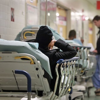 A patient lays on a stretcher as they wait to be treated in the Red Zone of the Grady Emergency Room at Grady Memorial Hospital Thursday morning in Atlanta, Ga., November 8, 2012. (Jason Getz/AJC 2012)
