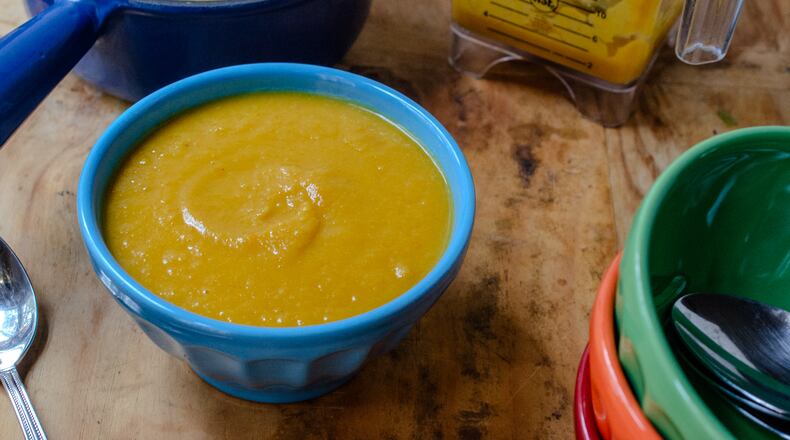 A bright and vibrant bowl of Sheet Pan Butternut Squash soup is a winner for nearly hands-free cooking. (Virginia Willis for The Atlanta Journal-Constitution)