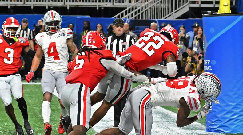 Ohio State wide receiver Marvin Harrison Jr. gets hit by Georgia defensive back Javon Bullard (22) during the Chick-fil-A Peach Bowl on Dec. 31. Bullard’s crushing hit has inspired a special cookie-dough dessert. (Hyosub Shin file photo / Hyosub.Shin@ajc.com)