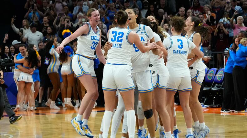 UCLA players celebrate after defeating South Carolina in the women's National Championship Final Four NCAA college basketball tournament game, Sunday, April 5, 2026, in Phoenix. (AP Photo/Ross D. Franklin)