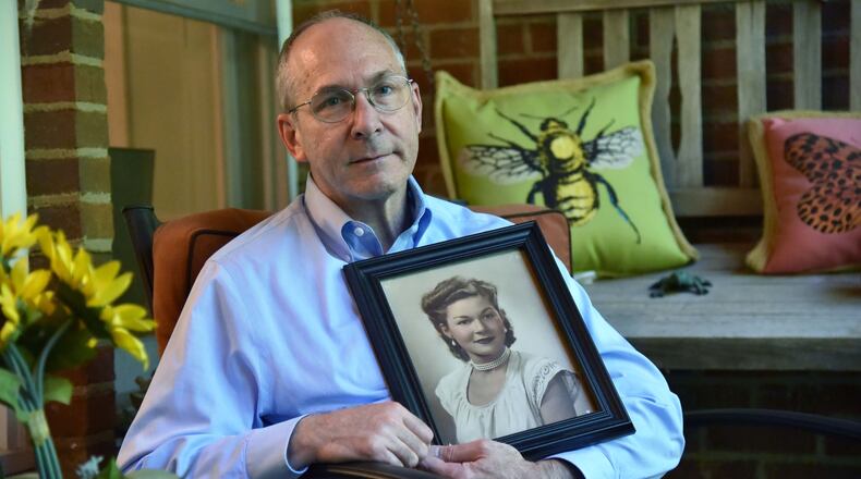 AJC Reporter Craig Schneider holds a portrait of his mother Anita Schneider. HYOSUB SHIN / HSHIN@AJC.COM