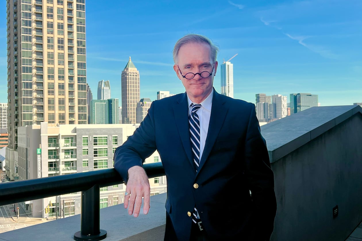 Rodney Mims Cook Jr. the newly installed chairman of the U.S. Commission of Fine Arts, stands at the top of Atlanta's Millennium Gate Museum, with the city skyline behind him, on Feb. 24, 2026. (Patricia Murphy/AJC)