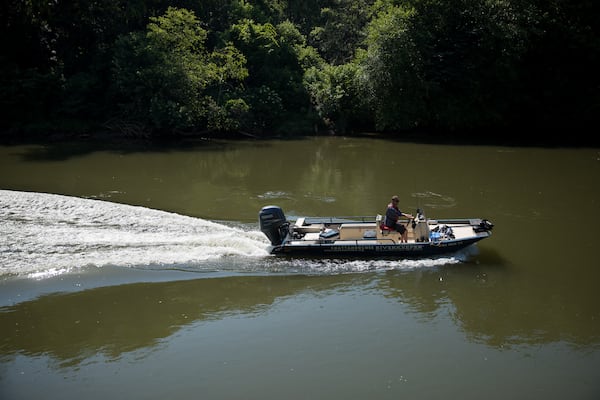 Jason Ulseth, the executive director of the Chattahoochee Riverkeeper,  navigates a boat down the Chattahoochee River on June 12, 2024. Riley Bunch/AJC