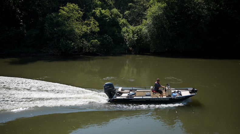 Chattahoochee Riverkeeper Executive Director Jason Ulseth scours the river for irregularities during a boat patrol ride with the organization on June 12. (Riley Bunch/AJC 2024)