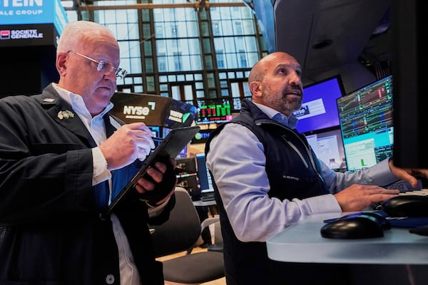 Trader Thomas Ferrigno, left, and specialist James Denaro work on the floor of the New York Stock Exchange, Tuesday, May 27, 2025. (AP Photo/Richard Drew)