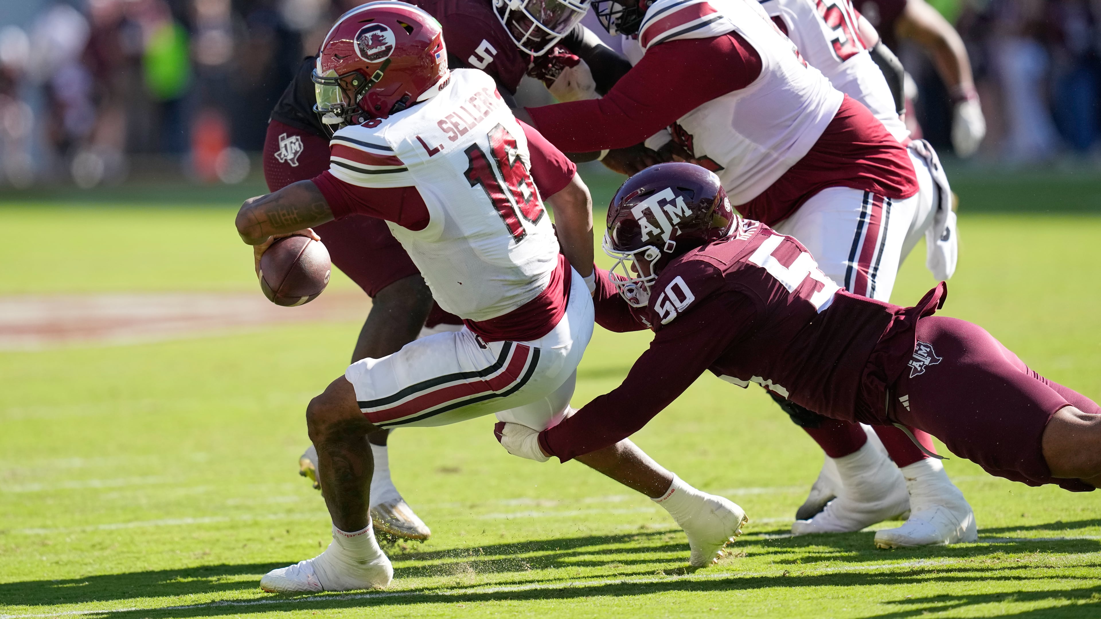South Carolina quarterback Lanorris Sellers (16) is sacked by Texas A&M defensive end Dayon Hayes (50) during the second half of an NCAA college football game Saturday, Nov. 15, 2025, in College Station, Texas. (AP Photo/David J. Phillip)