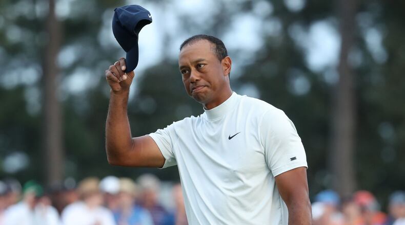 Tiger Woods tips his hat to the gallery as he leaves the 18th hole after coming within one stroke of the leaders during the second round of the Masters Tournament Friday, April 12, 2019, at Augusta National Golf Club in Augusta. Jason Getz / Special to the AJC