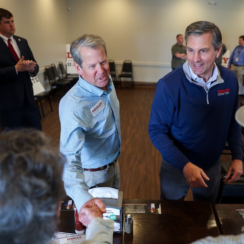 FILE - Gov. Brian Kemp, center left, and Republican U.S. Senate candidate Derek Dooley greet supporters at campaign stop for Dooley at Farmview Market in Madison, Ga., on May 8, 2026. (Arvin Temkar/Atlanta Journal-Constitution via AP, File)
