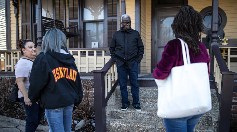 James Edigin (center) poses Saturday for a photo in front of the Rev. Martin Luther King Jr.'s childhood home shortly after a park ranger closed that part of the national historic site as a result of the government shutdown. The shutdown and its effect on national parks and other federal services continued into Sunday.