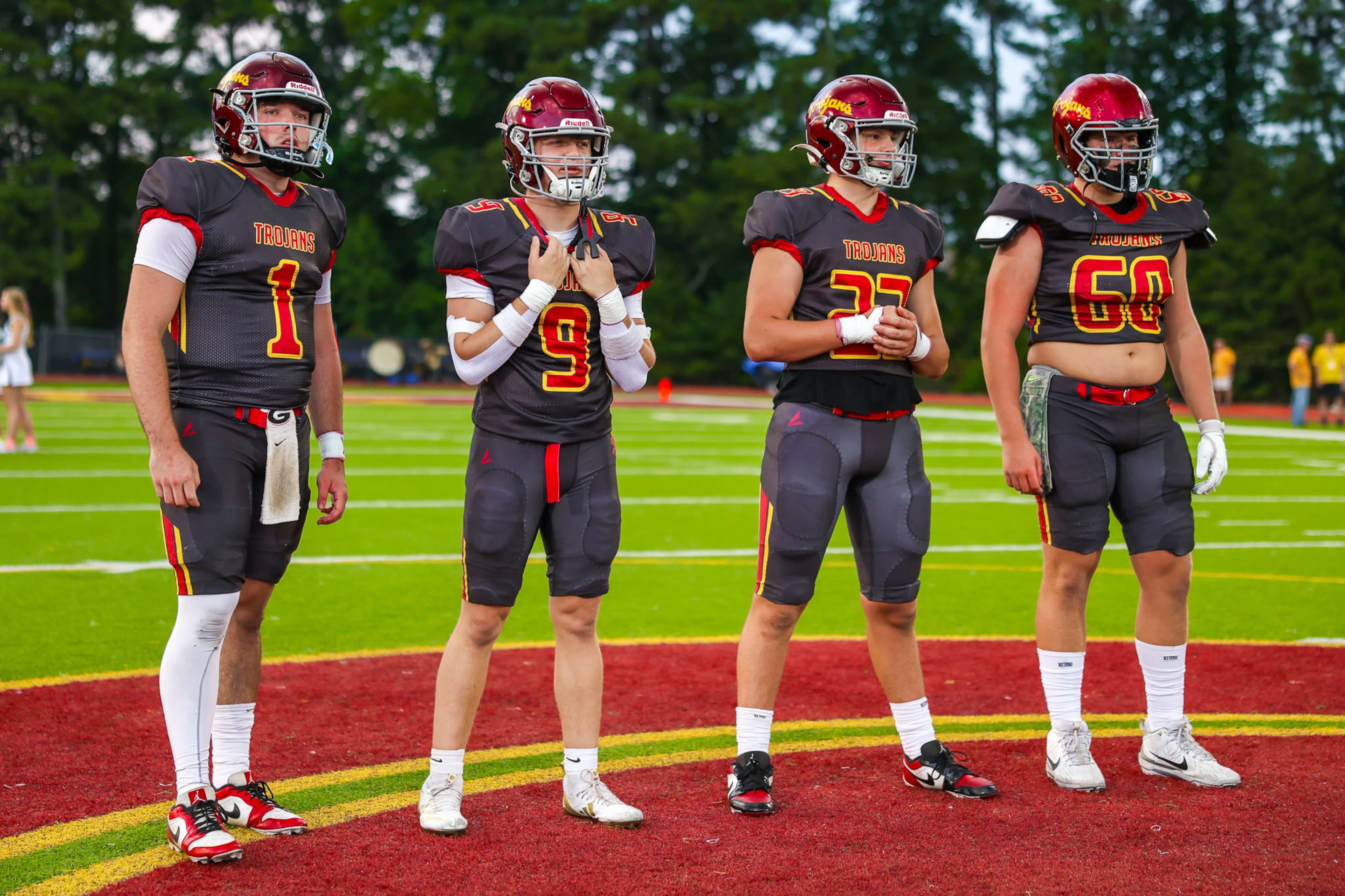 Lassiter players stand on the field before their matchup against Creekview at Lassiter High School on Friday, Sept. 5, 2025, in Marietta. (Oscar Guevara Saenz for the AJC)