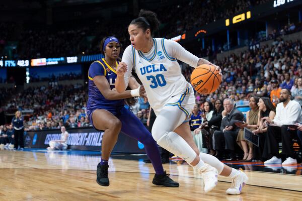 UCLA forward Timea Gardiner (30) drives to the basket during the first half of a game against LSU in the Elite Eight of the NCAA college basketball tournament, Sunday, March 30, 2025, in Spokane, Wash. (AP Photo/Jenny Kane)
