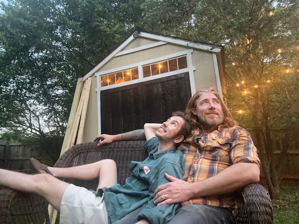 Cote, left, and Payne at home in their Decatur backyard in 2024. (Courtesy of Topher Payne and Charlie Cote)
