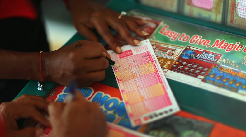 HOLLYWOOD, FL - NOVEMBER 28: Monti Young fills out her Powerball numbers as she buys a ticket at Circle News Stand on November 28, 2012 in Hollywood, Florida. The jackpot for Wednesday's Powerball drawing is currently at $550 million which is the richest Powerball pot ever. It is likely to rise even more as people continue to buy before tonights drawing. (Photo by Joe Raedle/Getty Images)