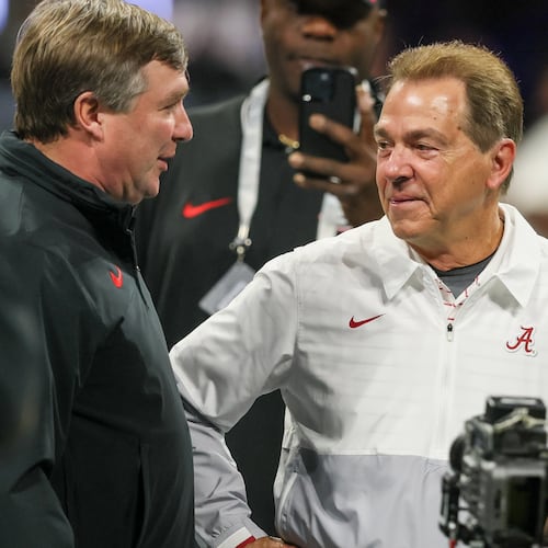 Former Alabama coach Nick Saban (right) — pictured with Georgia coach Kirby Smart before the 2023 SEC championship game — has been retired for more than two years, but he has continued to comment on college football and influence the game through his work on ESPN’s “College GameDay.” (Jason Getz/AJC)