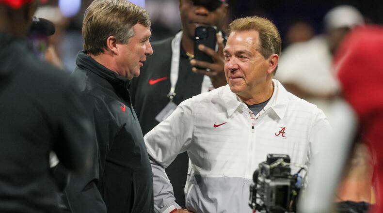 Former Alabama coach Nick Saban (right) — pictured with Georgia coach Kirby Smart before the 2023 SEC championship game — has been retired for more than two years, but he has continued to comment on college football and influence the game through his work on ESPN’s “College GameDay.” (Jason Getz/AJC)