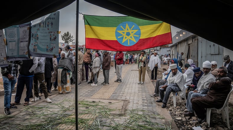 Ethiopian voters gather outside a polling station before voting begins in the general election in Addis Ababa, Ethiopia, Monday, June 1, 2026. (AP Photo/Amanuel Sileshi)