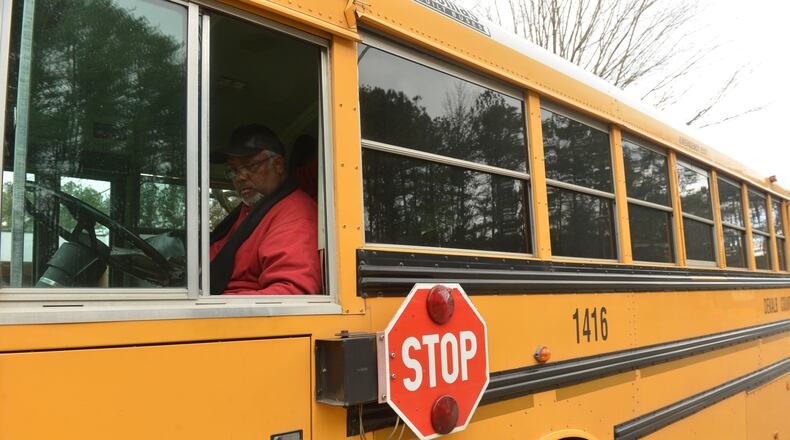 Bus driver David Warner of Newnan worked as students came out for dismissal at Woodridge Elementary School in Stone Mountain on Jan. 21, 2014. KENT D. JOHNSON/KDJOHNSON@AJC.COM