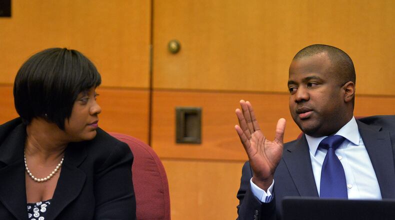 Defense attorney Benjamin Davis talks with his client Tamara Cotman, former Atlanta Public Schools regional director, before sentencing in 2015. (Kent D. Johnson/ The Atlanta Journal-Constitution)