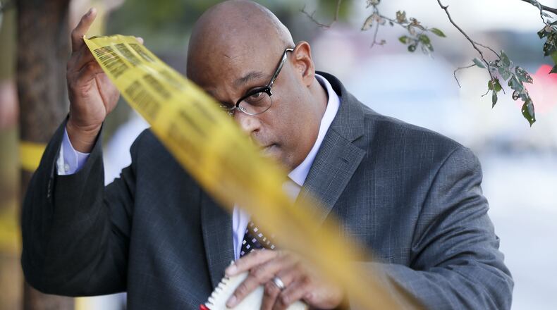 Cincinnati Police Chief Eliot Isaac ducks under police tape at the scene of a shooting Sept. 6, 2018, in downtown Cincinnati. Isaac announced Thursday, Dec. 20, 2018, that a 28-year veteran officer had been found dead inside a vehicle in the city's Eden Park. Dr. Lakshmi Sammarco, the Hamilton County coroner, said at the scene that the officer's death was not from natural causes.