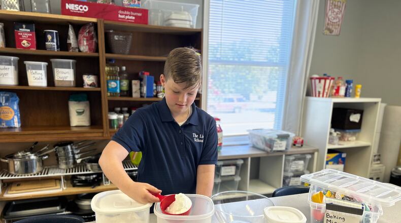 Student Ben Herbert measures ingredients for a cake as part of The Link School's life skills class.