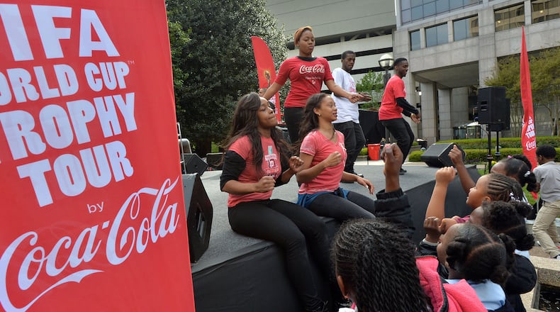 Staff members entertain children from Centers of Hope during the FIFA World Cup Trophy Tour event at Coca-Cola headquarters in Atlanta on Thursday, April 17.