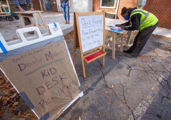Mario McKee signs in to receive his desk at the Decatur Makers on Friday, November 11, 2020.  STEVE SCHAEFER FOR THE ATLANTA JOURNAL-CONSTITUTION  
