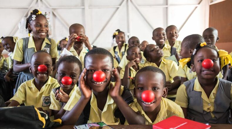 Red Nose Day has raised more than $1 billion since 1988 to help children worldwide stay healthy, safe and educated. Here, Haitian students show off their red noses after receiving a grant.