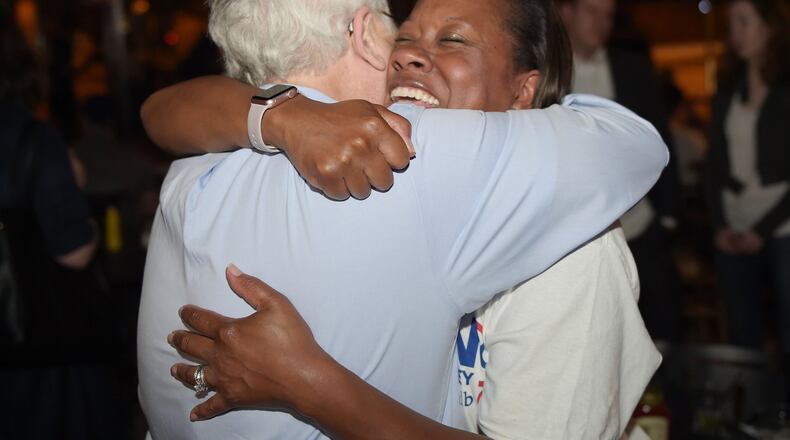 DeKalb DA candidate Sherry Boston celebrates with former prosecutor Bob Wilson at a watch party where she celebrated her win over incumbent Robert James during Tuesday’s primary. KENT D. JOHNSON/kdjohnson@ajc.com